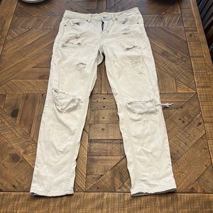 White Washed Jeans with distressing. Holes are worn. Size 25. Mid rise.